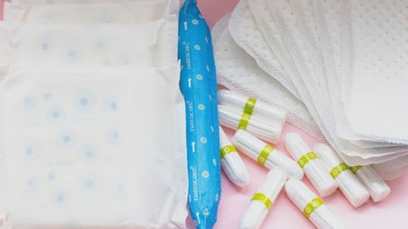 Sanitary products including pads and tampons on a pink background